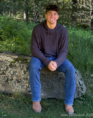 Nick in sweater sitting on rock