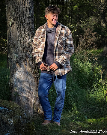 Nick in shirt standing against tree
