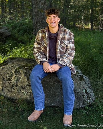 Nick in shirt sitting on rock